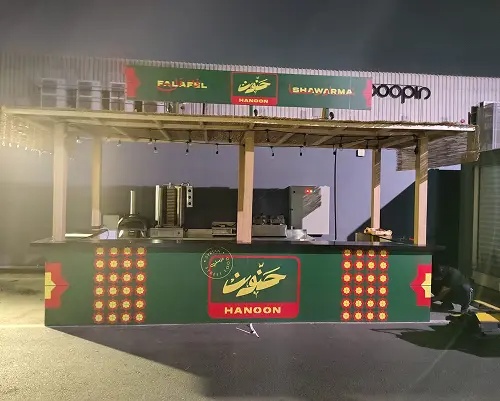 applying outdoor signage on a cart in an event